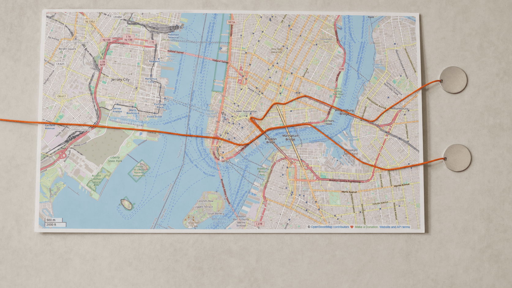 A real New York City street map branching along a burnt-orange route cord into two separate self-guided routes