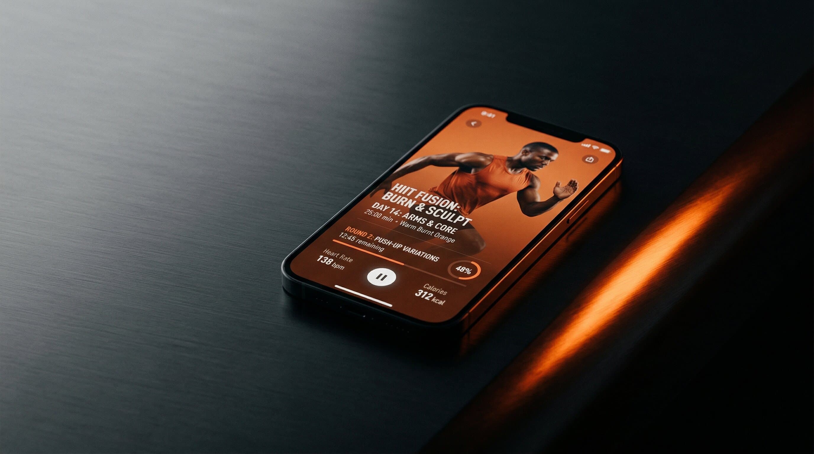 A fitness app on a phone sitting on a dark surface with warm orange accent lighting
