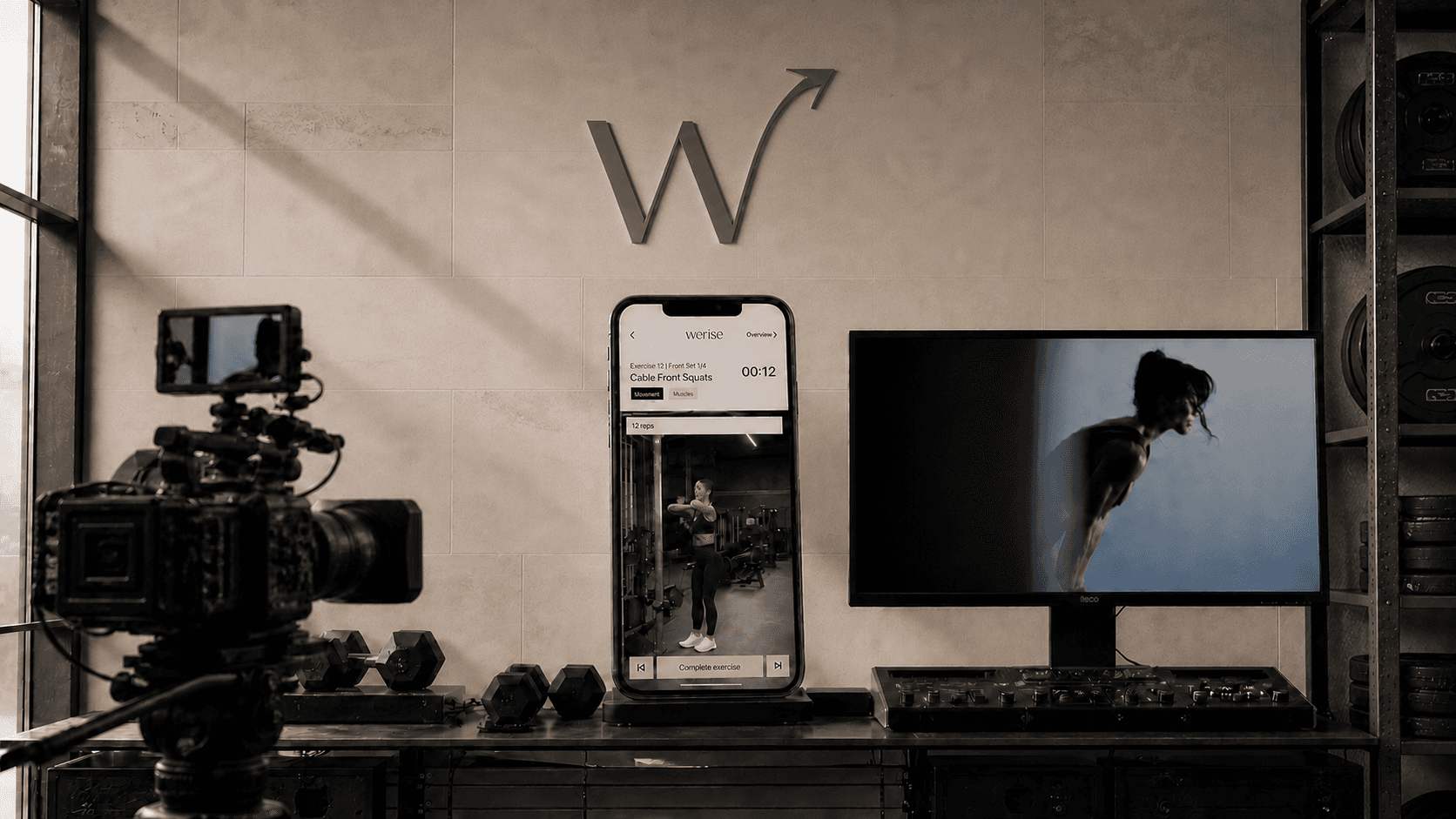 A professional camera, authentic WeRise workout screen, and editing monitor show how a creator-owned product becomes the next piece of content