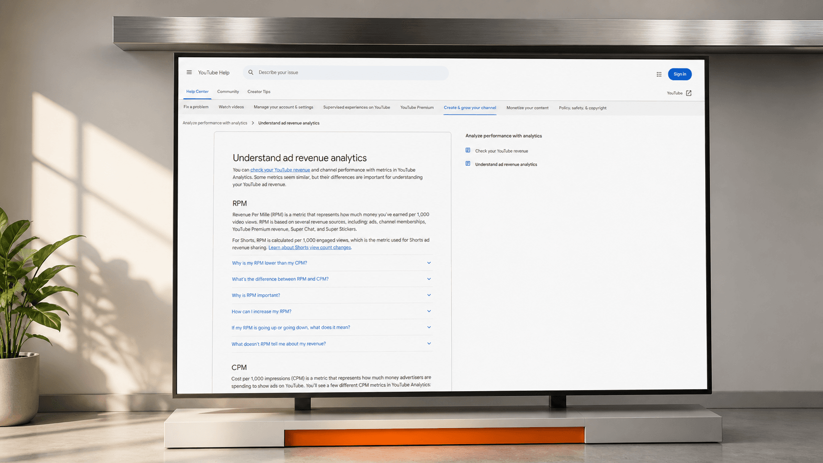 The official YouTube RPM help page displayed beneath a low steel ceiling bar, showing that the platform defines and caps the rate